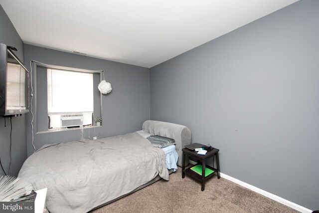 bedroom with cooling unit and carpet flooring