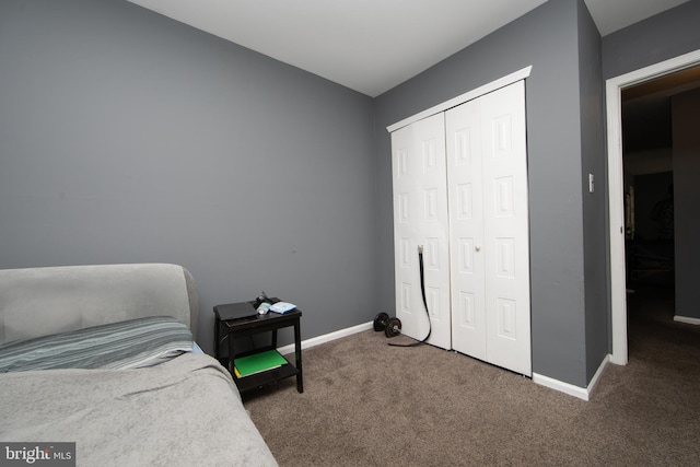 bedroom with dark carpet and a closet