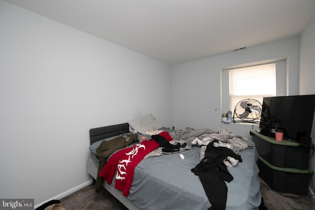 bedroom with dark colored carpet