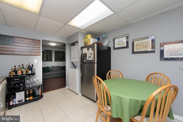 dining room featuring a paneled ceiling and light tile patterned floors