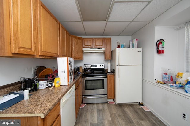 kitchen featuring white appliances, dark hardwood / wood-style flooring, and a drop ceiling