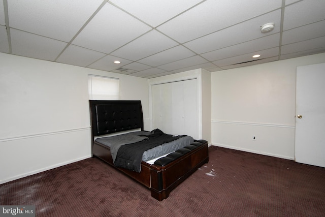 carpeted bedroom with a paneled ceiling