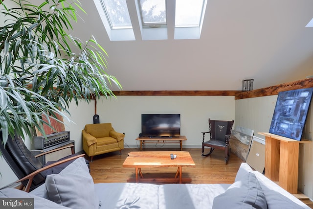 living room with a skylight and hardwood / wood-style flooring