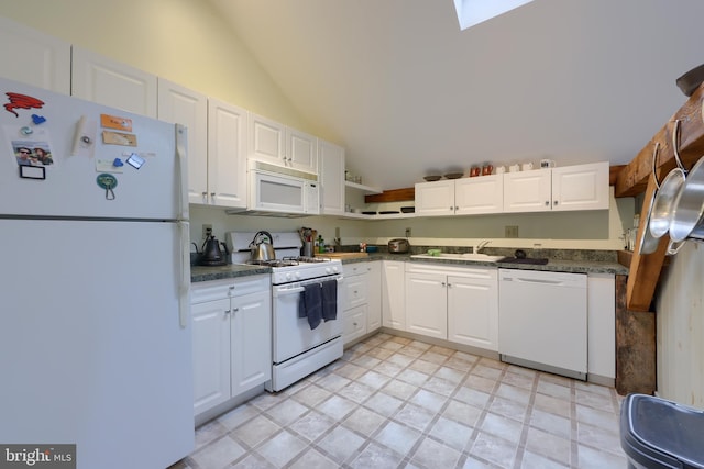 kitchen with light tile patterned floors, high vaulted ceiling, white appliances, and white cabinetry