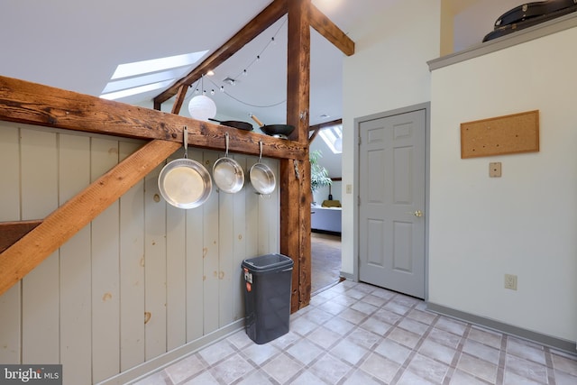 room details with a skylight, tile patterned floors, and beamed ceiling