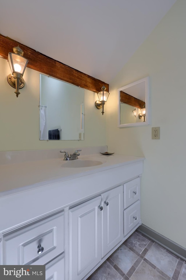 bathroom featuring tile patterned floors, vanity, and vaulted ceiling