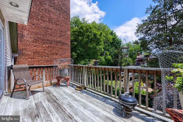 wooden deck with a grill