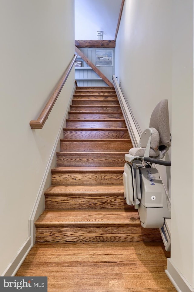 stairway with hardwood / wood-style flooring