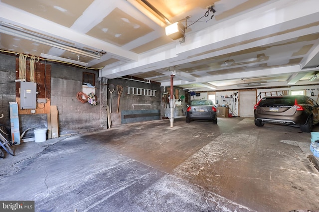 garage with electric panel and a garage door opener