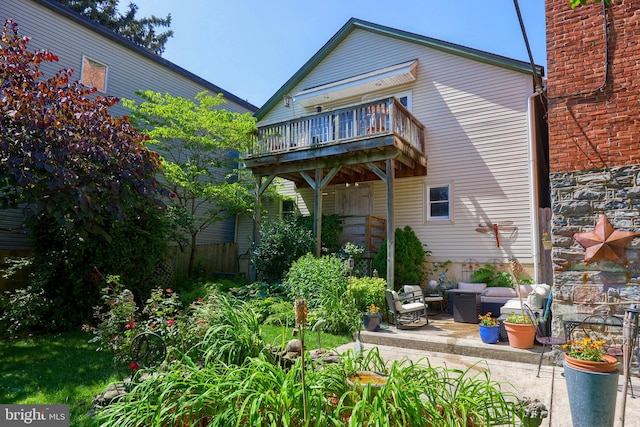 rear view of house with outdoor lounge area, a patio area, and a balcony