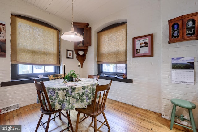 dining area with light wood-type flooring and a healthy amount of sunlight