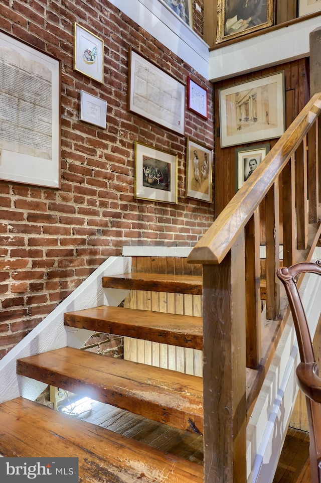 staircase with brick wall