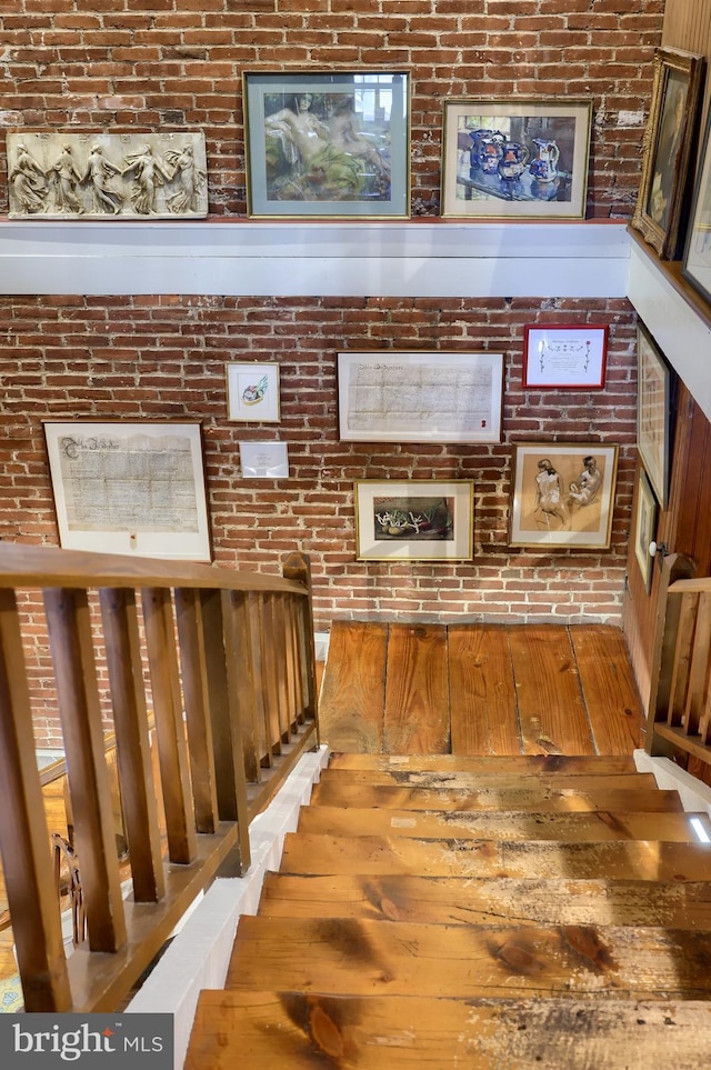 stairs featuring brick wall