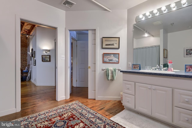 bathroom featuring hardwood / wood-style flooring and vanity