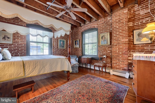 bedroom featuring hardwood / wood-style floors, beamed ceiling, multiple windows, and ceiling fan