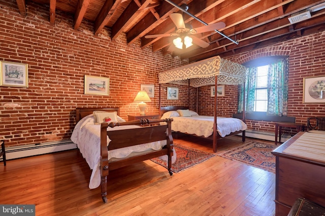 bedroom with beamed ceiling, wood-type flooring, ceiling fan, and brick wall