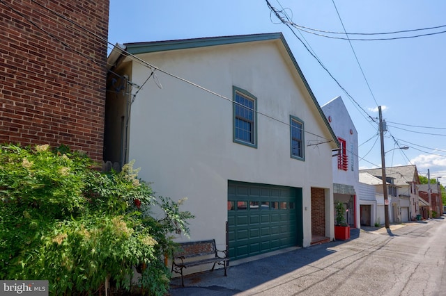 view of side of home with a garage