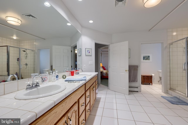 bathroom featuring dual vanity, tile patterned floors, and walk in shower