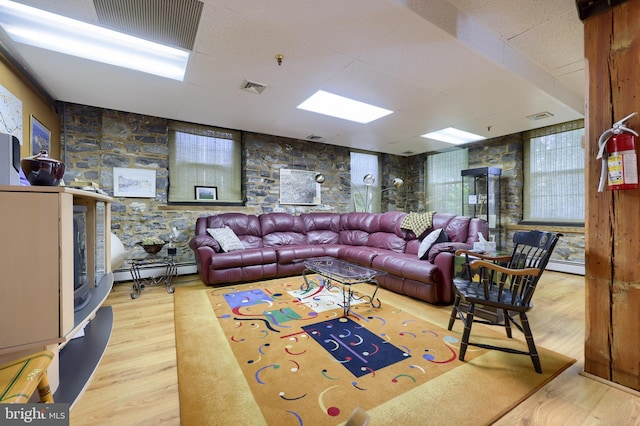 living room featuring wood-type flooring and a baseboard radiator