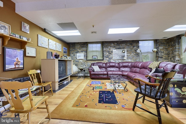 living room featuring a paneled ceiling and light wood-type flooring