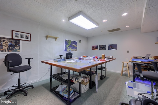 carpeted office with a paneled ceiling