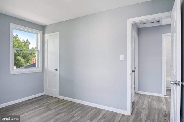 spare room featuring wood-type flooring