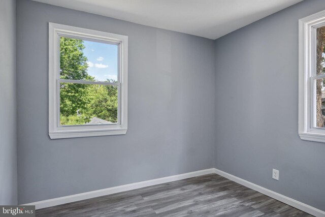 unfurnished room featuring plenty of natural light and hardwood / wood-style floors