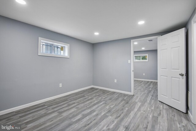 basement with wood-type flooring and a healthy amount of sunlight