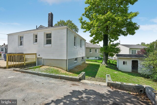 exterior space featuring a lawn and a storage shed