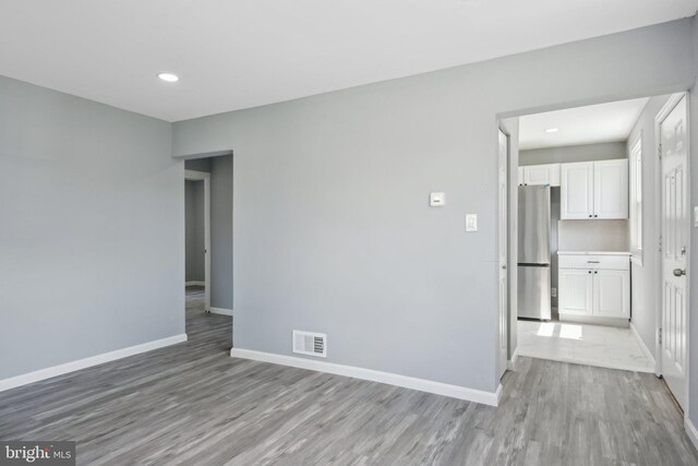 unfurnished room with light hardwood / wood-style flooring