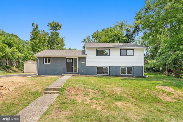 split level home featuring a storage shed and a front lawn