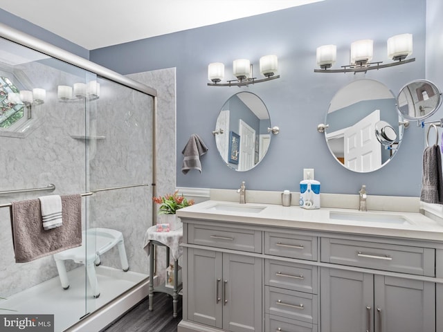 bathroom with vanity, hardwood / wood-style floors, and an enclosed shower