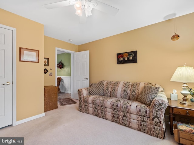 carpeted living room featuring ceiling fan