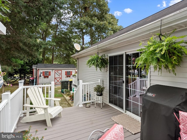 deck featuring area for grilling and a shed