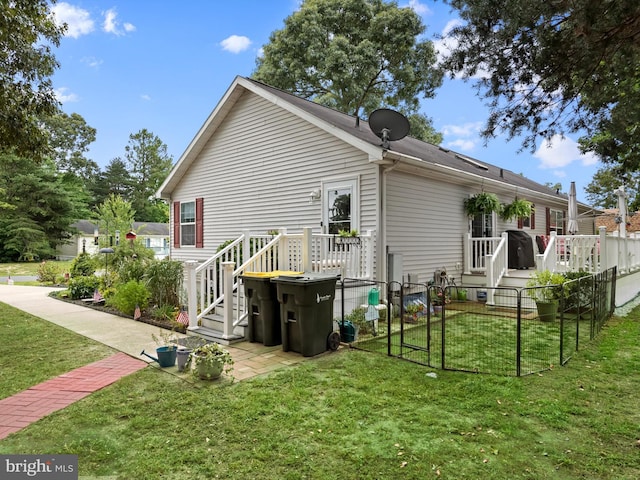 rear view of house featuring a lawn