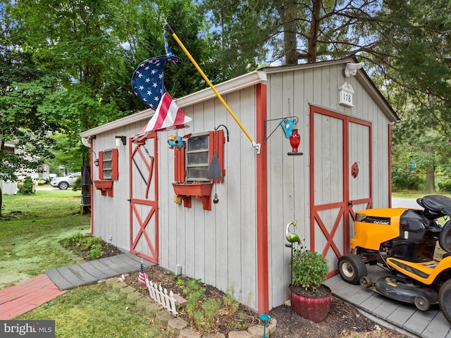 view of outbuilding with a lawn