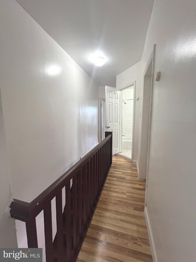 hallway with hardwood / wood-style flooring