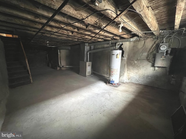 basement featuring heating unit and water heater