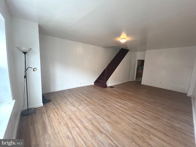 additional living space featuring hardwood / wood-style floors