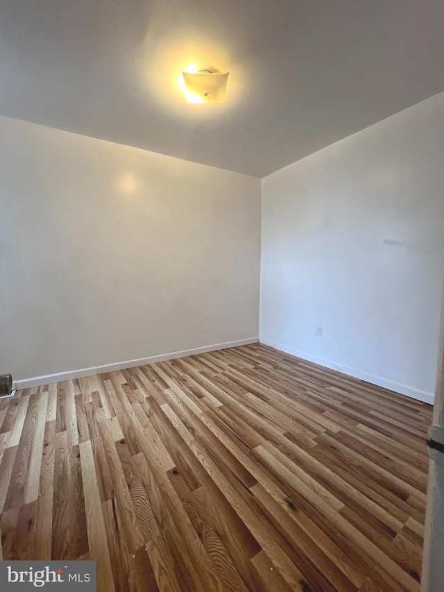 empty room with hardwood / wood-style floors