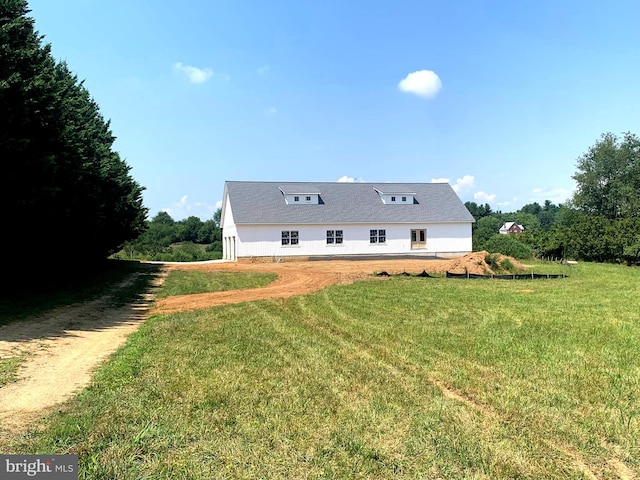 rear view of house with a yard