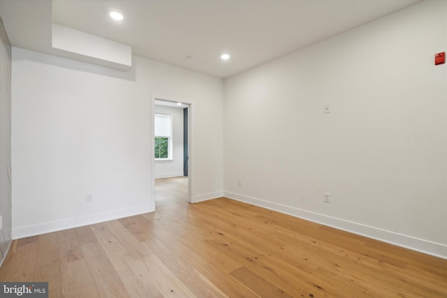 unfurnished room with light hardwood / wood-style floors