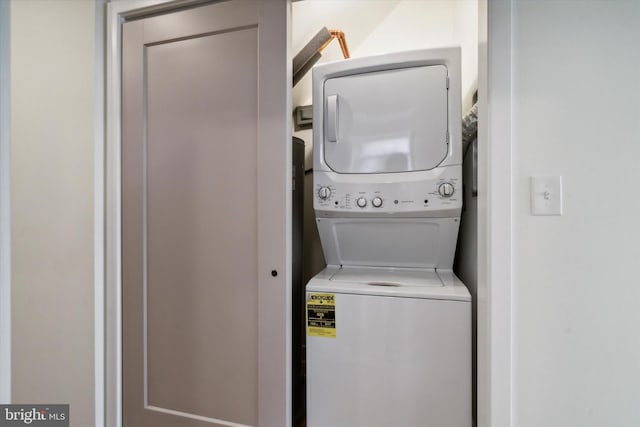 clothes washing area with stacked washer and dryer