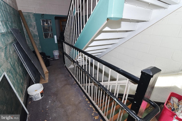 staircase with concrete flooring