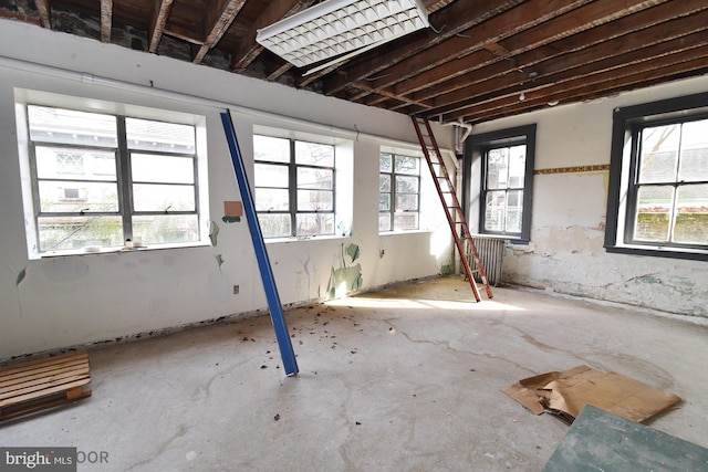 misc room featuring concrete flooring and a healthy amount of sunlight