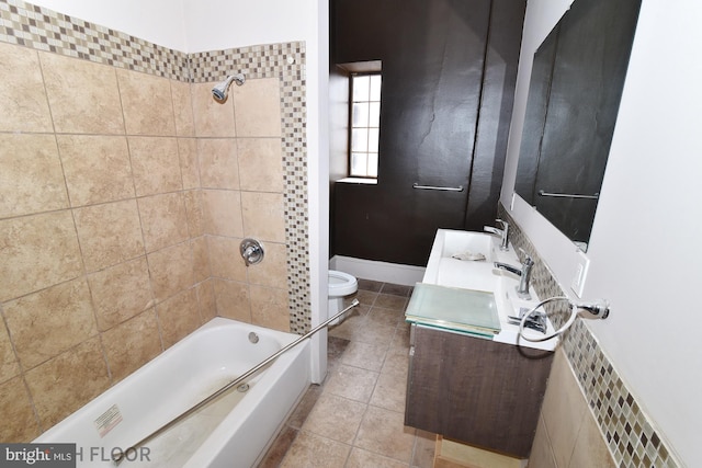 full bathroom featuring vanity, tile patterned floors, toilet, and tiled shower / bath