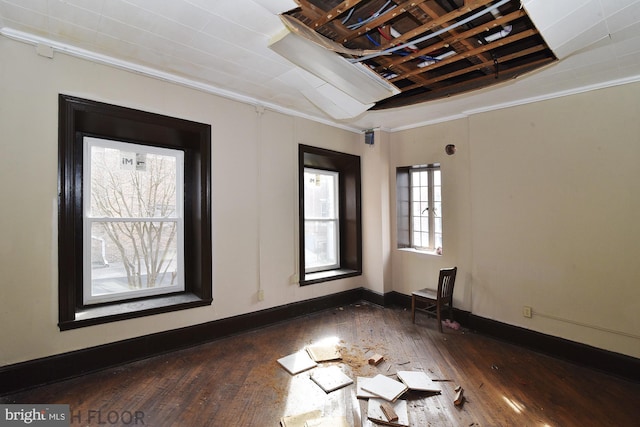 unfurnished room with dark wood-type flooring and ornamental molding