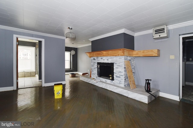 unfurnished living room featuring a tiled fireplace, crown molding, and dark hardwood / wood-style flooring