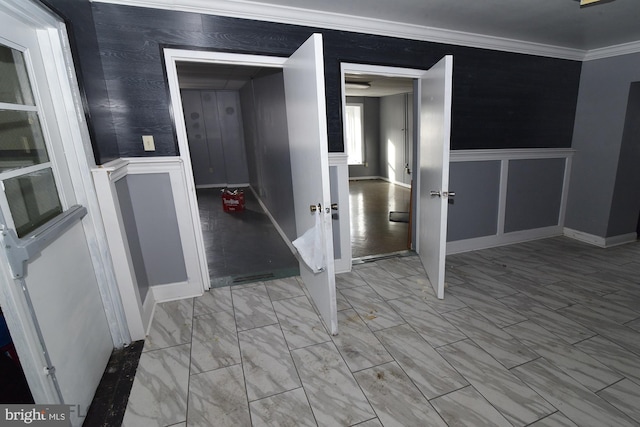 hallway featuring light tile patterned floors and ornamental molding