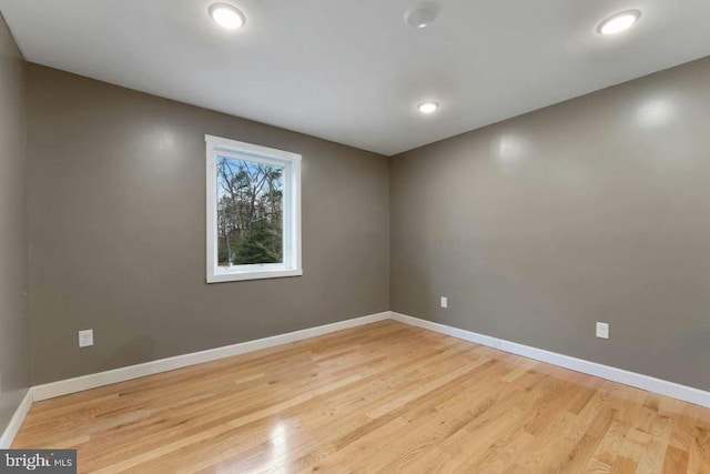 unfurnished room with light wood-type flooring